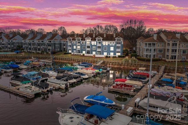 aerial view at dusk featuring a water view