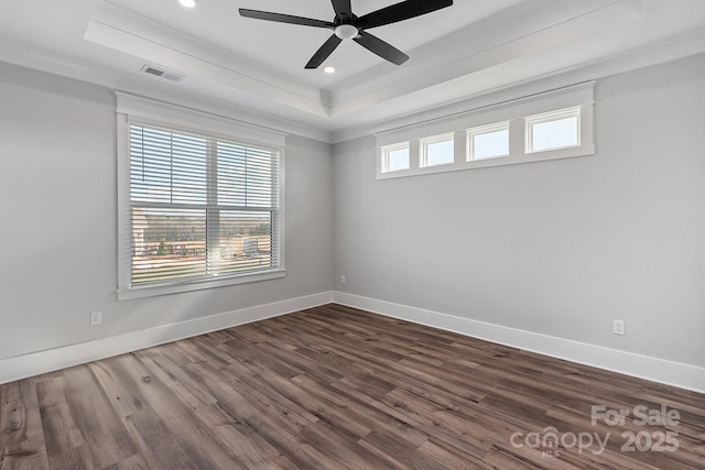 spare room featuring ceiling fan, ornamental molding, dark hardwood / wood-style flooring, and a raised ceiling