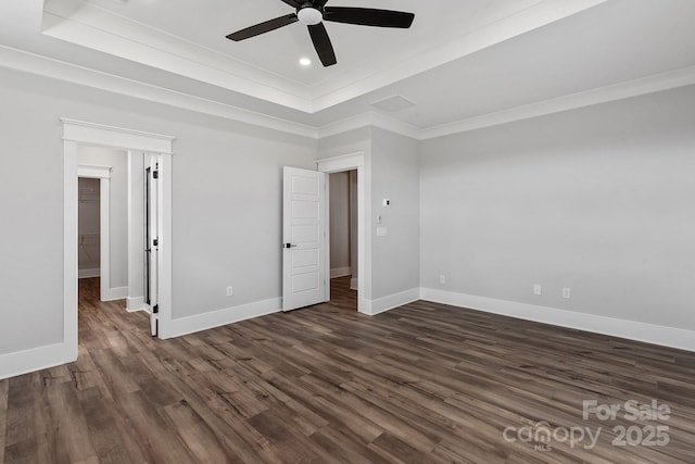 unfurnished bedroom with a raised ceiling, ornamental molding, dark hardwood / wood-style floors, and ceiling fan