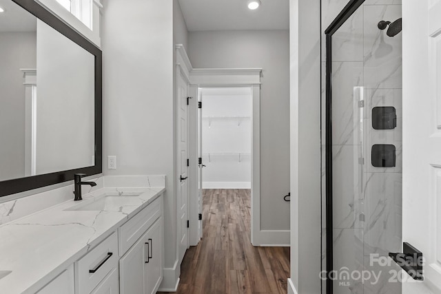 bathroom with vanity, hardwood / wood-style floors, and an enclosed shower