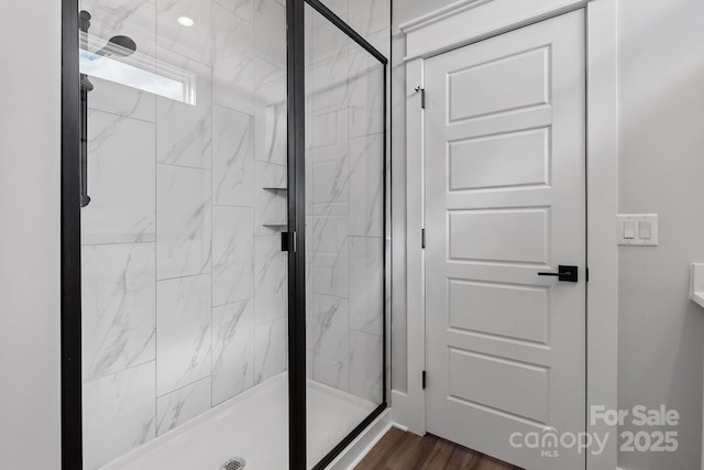 bathroom with walk in shower and wood-type flooring