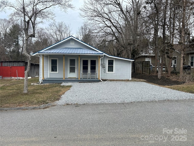 view of front of home with covered porch and a front yard