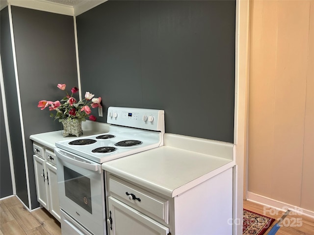 kitchen featuring white electric stove, light hardwood / wood-style flooring, and white cabinets