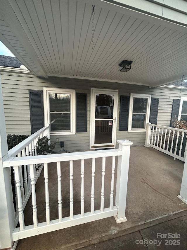 view of exterior entry with covered porch