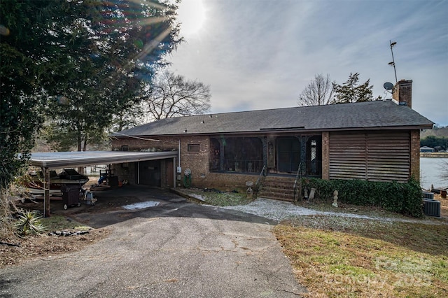 view of front of home with cooling unit and a carport