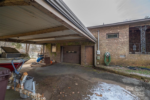 view of home's exterior with a garage and a carport