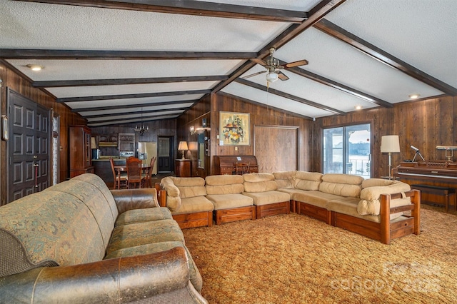 carpeted living room featuring vaulted ceiling with beams, ceiling fan, and wood walls