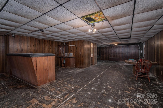 bar with a drop ceiling and wood walls