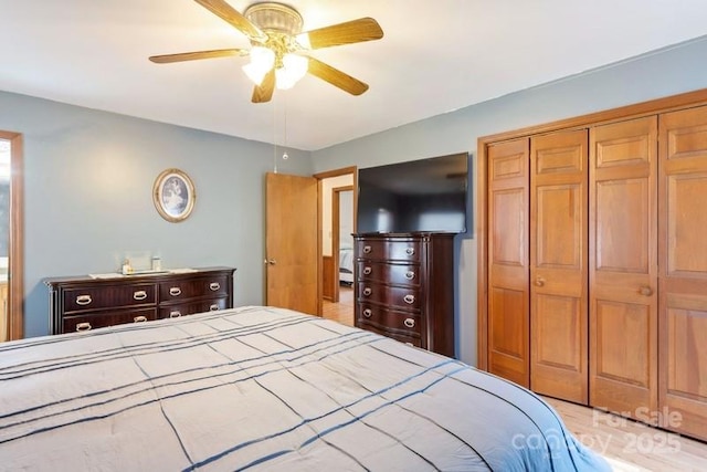 bedroom featuring ceiling fan and a closet