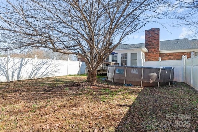 view of yard with a fenced in pool