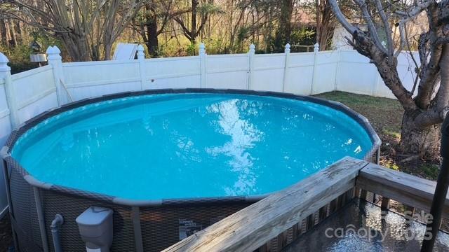 view of pool with a fenced in pool and fence