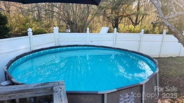 view of pool featuring fence