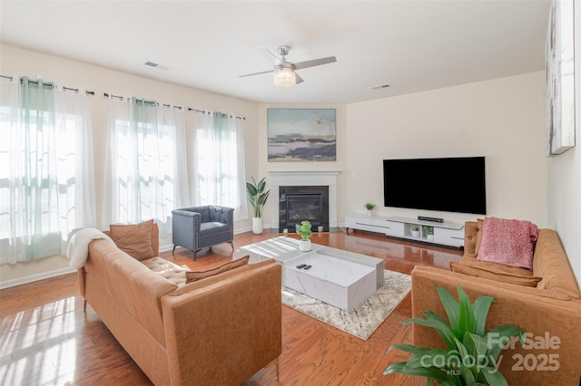 living room featuring ceiling fan and wood-type flooring