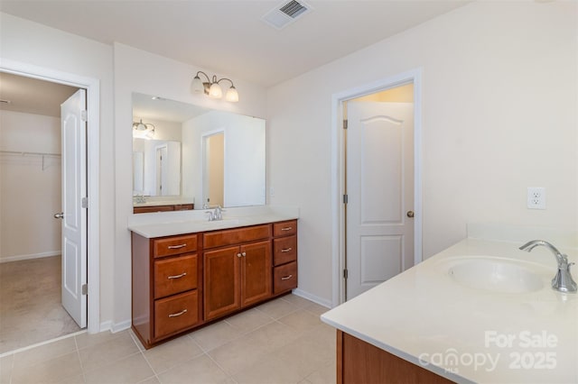bathroom with tile patterned floors and vanity