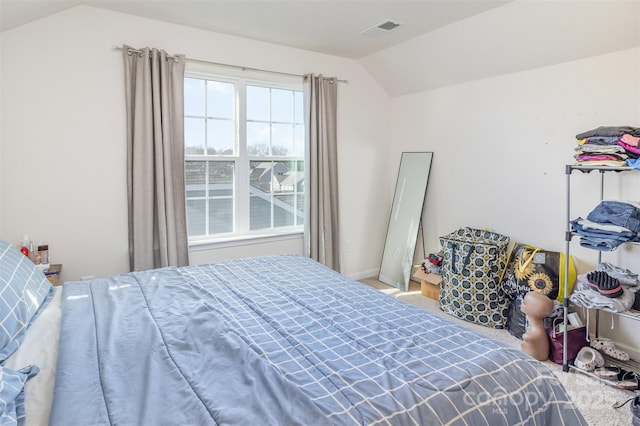 carpeted bedroom featuring vaulted ceiling