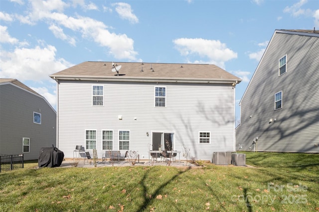 back of property featuring central AC unit, a lawn, and a patio