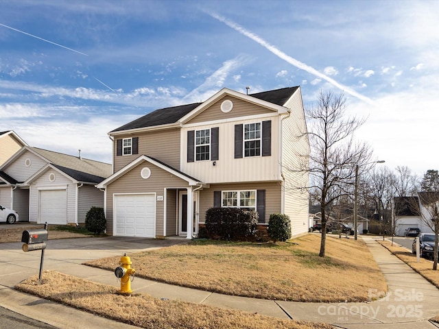 view of property with a garage and a front yard