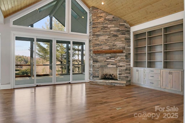 unfurnished living room with wood ceiling, high vaulted ceiling, hardwood / wood-style flooring, built in features, and beamed ceiling