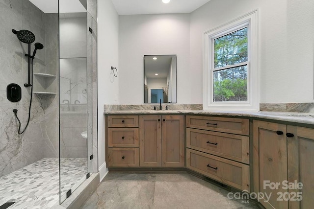 bathroom featuring an enclosed shower and vanity