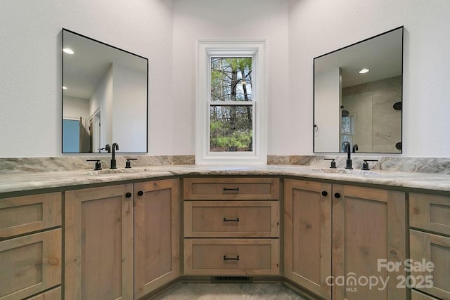 bathroom with walk in shower and vanity