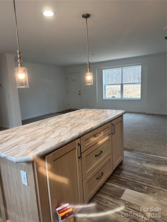 kitchen with light brown cabinetry, pendant lighting, dark wood-type flooring, and a center island