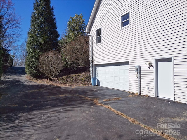 view of property exterior with a garage