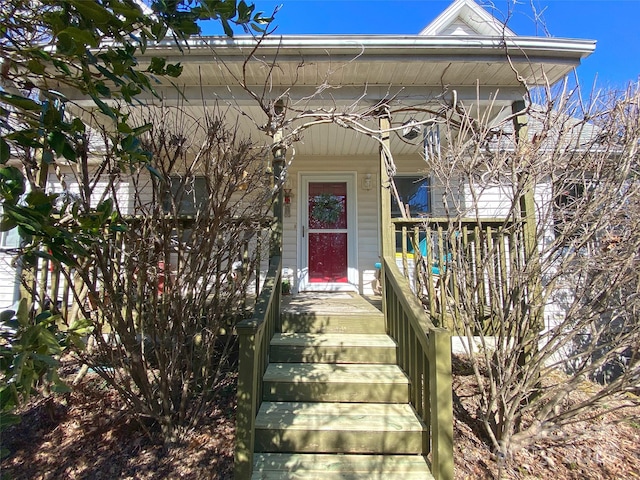 entrance to property featuring a porch