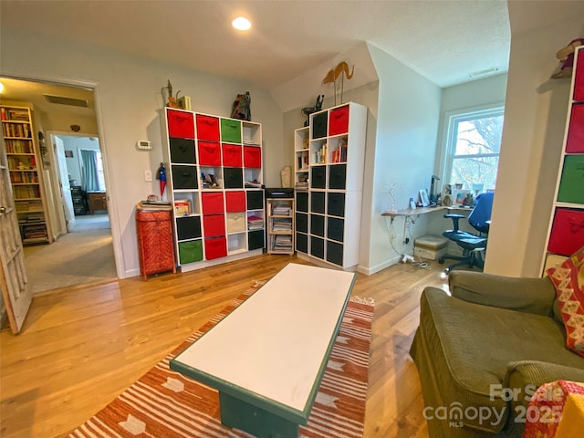 interior space with baseboards, visible vents, wood finished floors, and recessed lighting