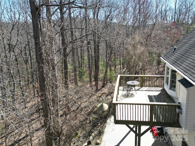 wooden deck with a forest view