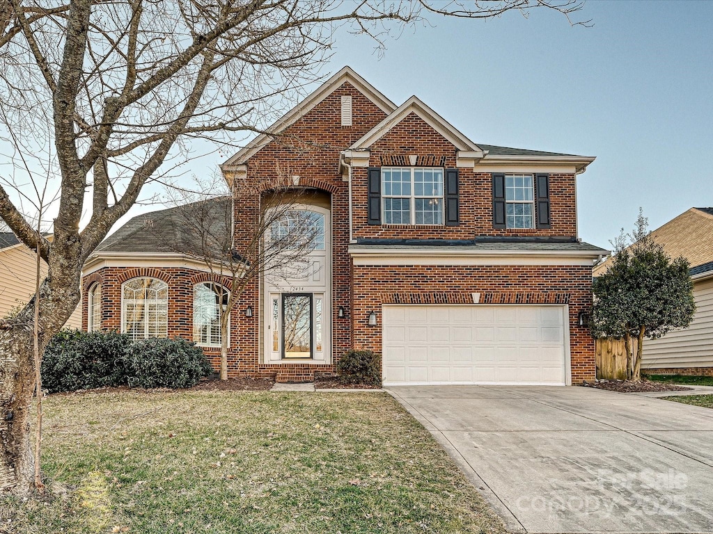 view of front of house with a garage and a front yard