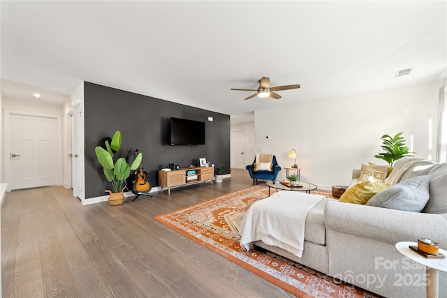 living room featuring hardwood / wood-style flooring and ceiling fan