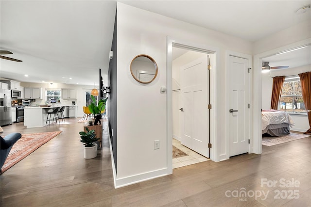 corridor with light hardwood / wood-style flooring