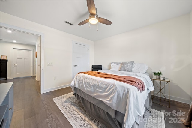 bedroom with ceiling fan and dark hardwood / wood-style floors