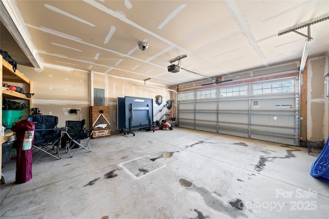 garage with a garage door opener and electric panel