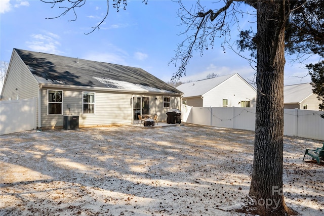 back of house with central AC and a fire pit