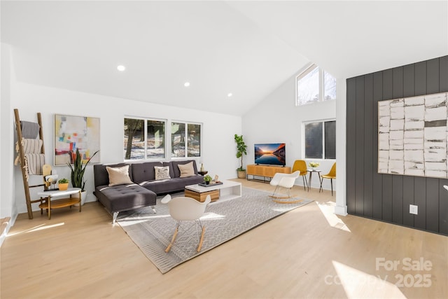 living room featuring light wood-type flooring and high vaulted ceiling