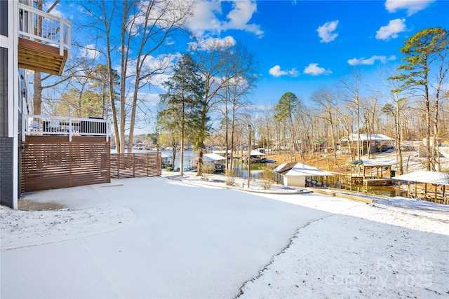 snowy yard with a water view