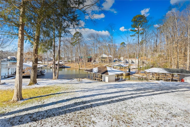 view of yard featuring a boat dock and a water view