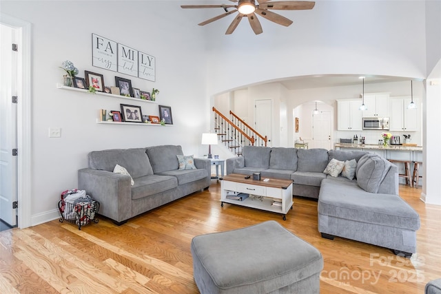 living room featuring ceiling fan and light hardwood / wood-style floors