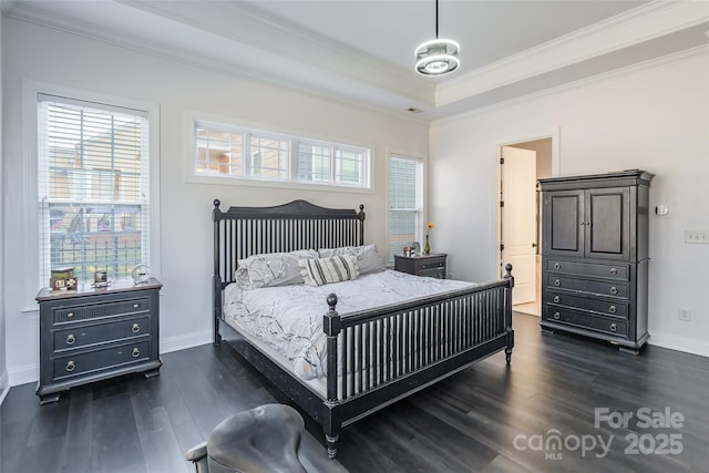 bedroom with a tray ceiling, crown molding, and dark hardwood / wood-style floors