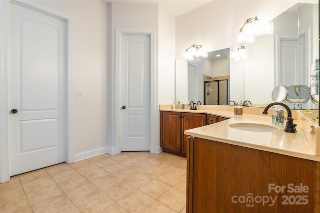 bathroom with tile patterned floors, a shower with shower door, and vanity