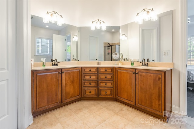 bathroom with vanity, a shower with door, and tile patterned floors