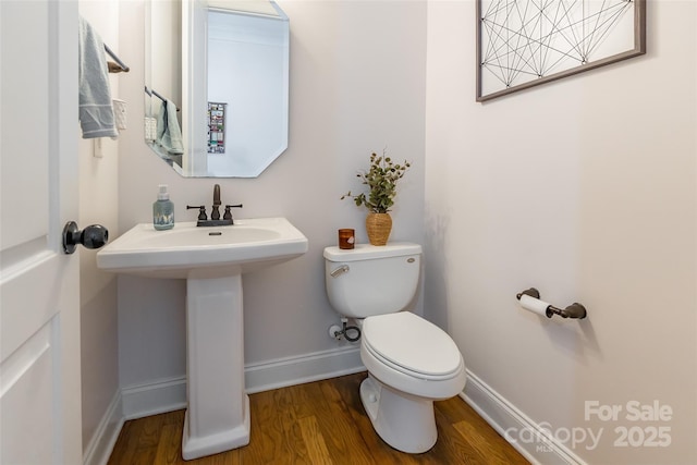 bathroom featuring wood-type flooring, sink, and toilet