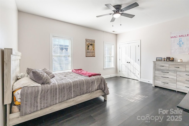 bedroom featuring a closet, dark hardwood / wood-style floors, and ceiling fan