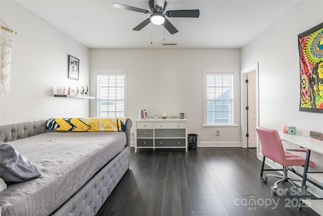 bedroom with dark hardwood / wood-style floors and ceiling fan