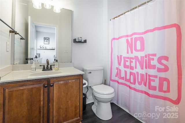 bathroom with vanity, hardwood / wood-style floors, a shower with curtain, and toilet