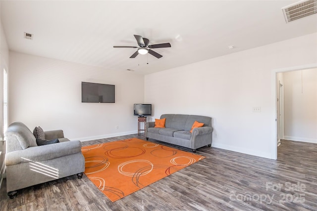 living room with ceiling fan and dark hardwood / wood-style flooring