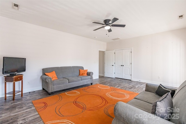 living room with dark hardwood / wood-style floors and ceiling fan