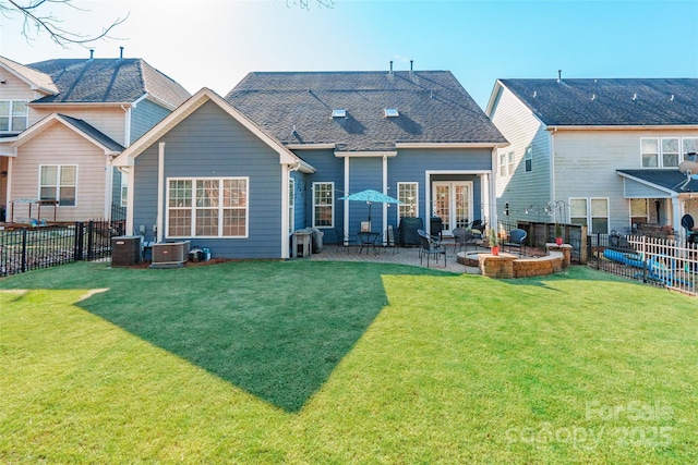 rear view of property featuring a lawn, cooling unit, and a patio area