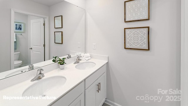 bathroom featuring vanity and toilet